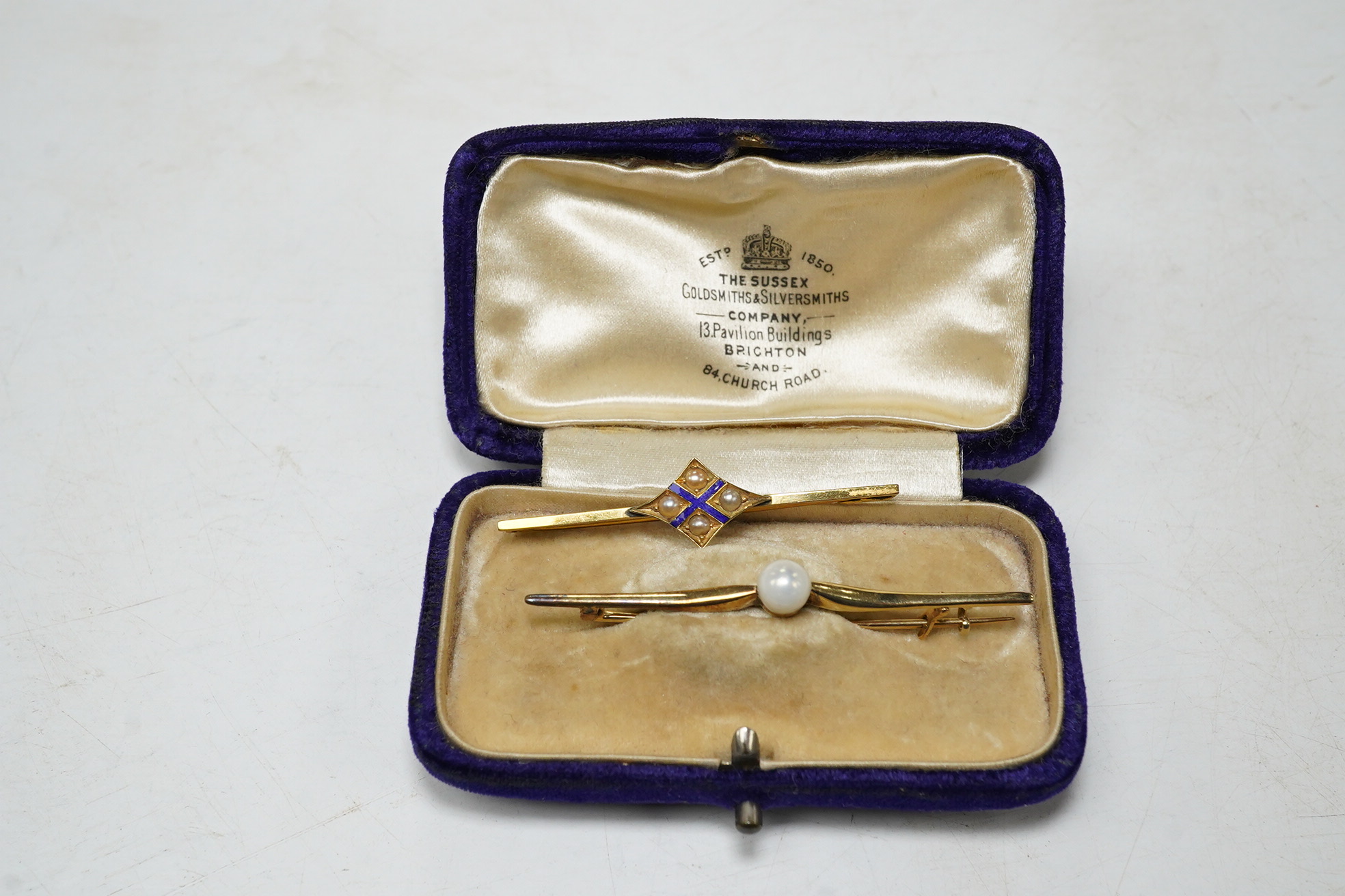 A 9ct gold split pearl and enamel set bar brooch, 1.9 grams, and a cased yellow metal pearl set bar brooch. Condition - good